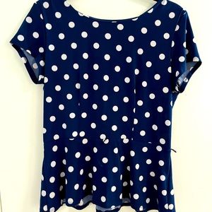 Very flattering navy and white polka dot peplum blouse. Size Petite L